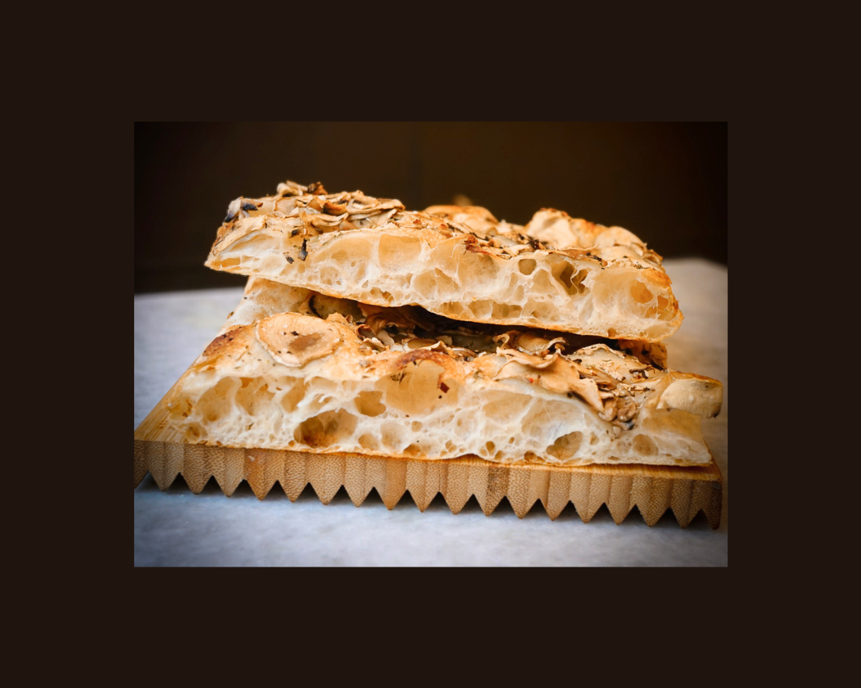 Authentic Roman pizza showing its airy crumb structure and crispy crust.